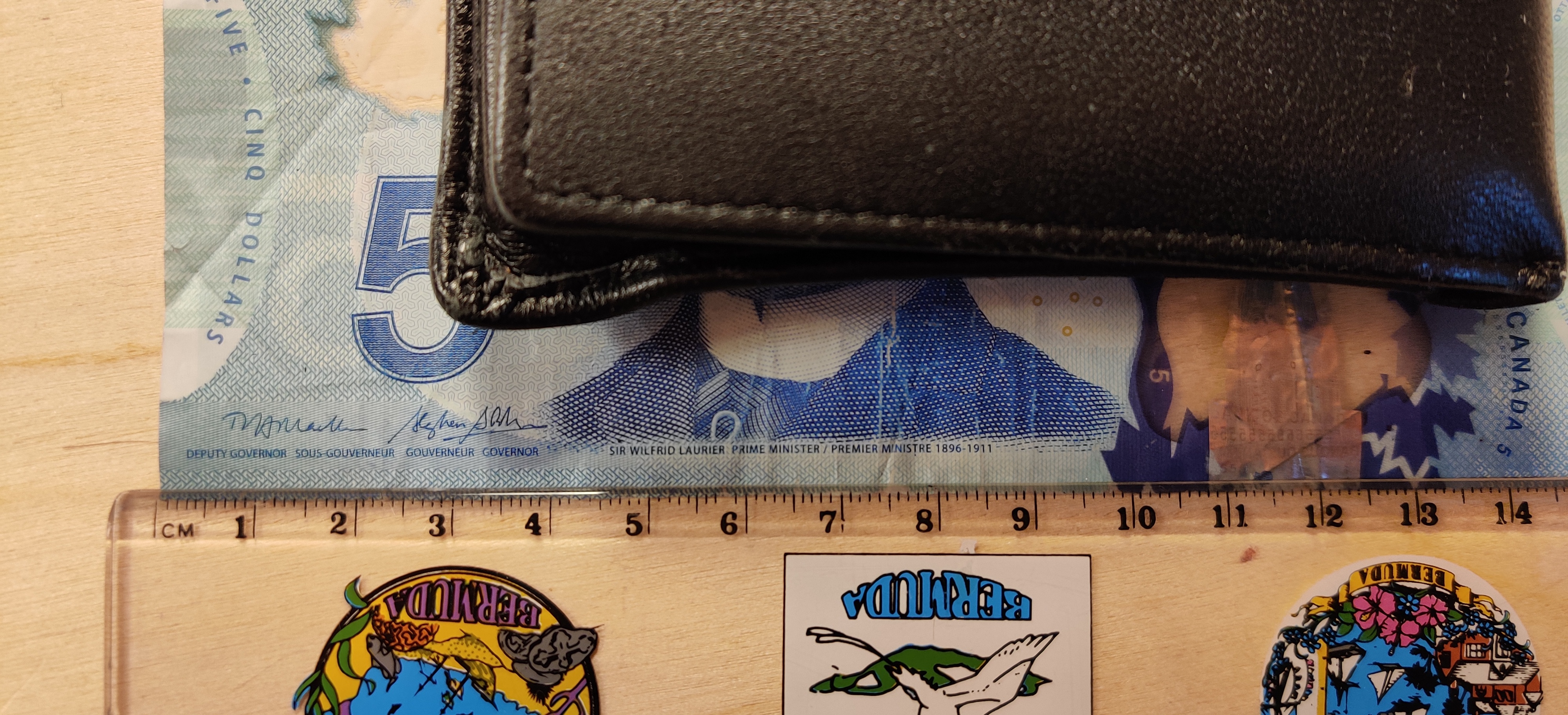 A ruler next to a Canadian $5.